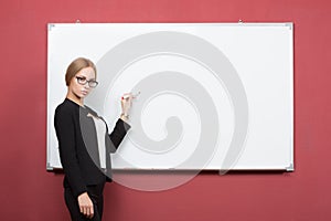 Business woman pointing at the whiteboard