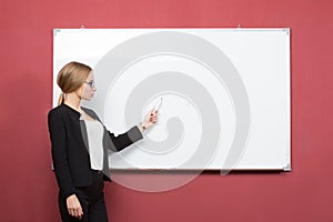 Business woman pointing at the whiteboard