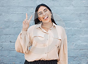 Business woman, portrait and tongue out with peace sign against a gray wall background. Happy and goofy female face