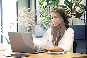 Business woman preparing a meeting in her laptop