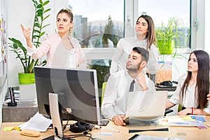 Business woman presenting to colleagues during meeting at office.