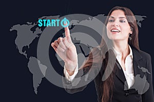 Business woman pressing start button on digital transparent scre