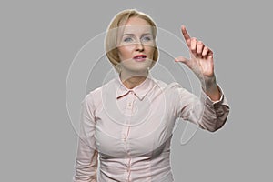 Business woman pressing and swiping an invisible virtual screen.