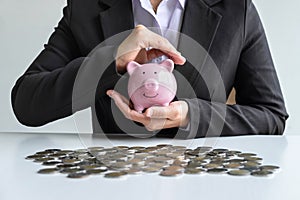 Business woman protect piggy bank planning for step up growing business to profit and saving with money box, Saving money for