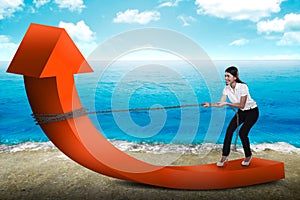 Business woman pulling arrow with chain