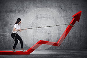 Business Woman Pulling Arrow With Chain