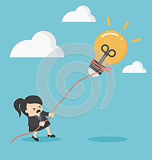 Business woman pulling bulb with rope