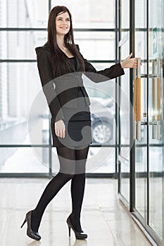 Business woman pulling the door handle photo