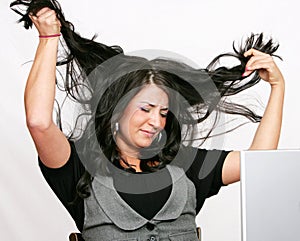 Business woman pulling her hair out