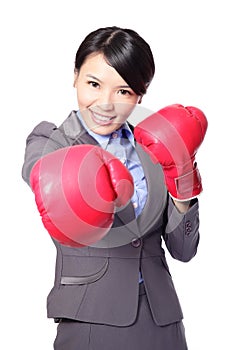 Business woman punching by boxing gloves