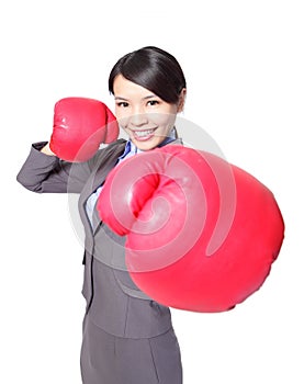 Business woman punching by boxing gloves