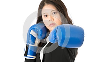 Business woman punching towards camera