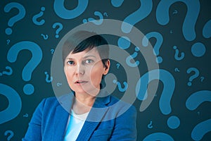 Business woman with question marks looking for answers