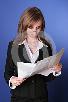 Business woman reading carefully a file