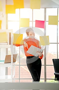 Business woman is reading documents view through window