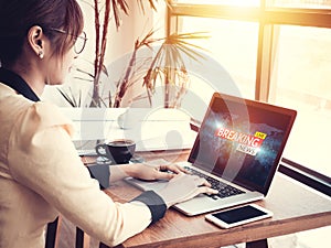 Business woman reading fake news or HOAX on internet content via laptop at workplace photo