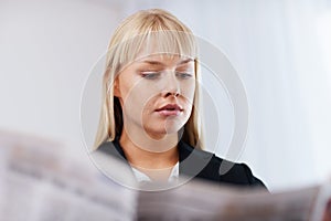 Business woman reading newspaper. Closeup of beautiful business woman reading newspaper.