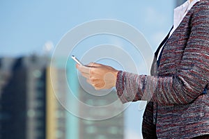 Business woman reading text message in the city