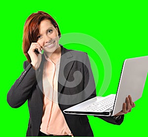 Business woman with red hair talking on the mobile cell phone holding laptop in hand isolated on green screen croma