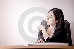 Business woman resting and massaging her shoulder in office chair