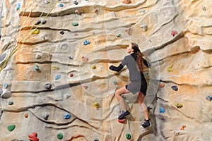 Business woman on rock wall