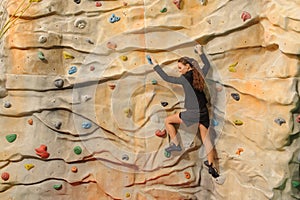 Business woman on rock wall