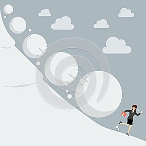 Business woman running away from snowball effect