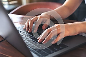 A business woman`s hands working and typing on laptop keyboard