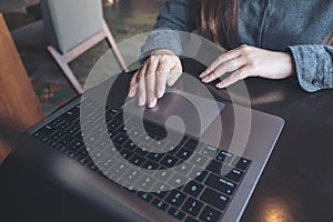 A business woman`s hands working and typing on laptop keyboard on the table