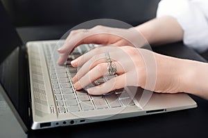 Business Woman's Workspace. Female Hands on Laptop Keyboard. Close-Up. Female Hands Typing on Computer Keyboard for