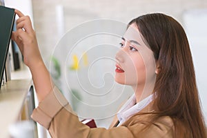 Business woman Searching files and and reading book in the cabinet or books shelves