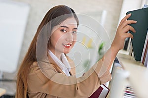 Business woman Searching files and and reading book in the cabinet or books shelves