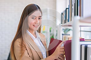 Business woman Searching files and and reading book in the cabinet or books shelves