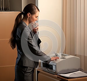 Business woman sending fax