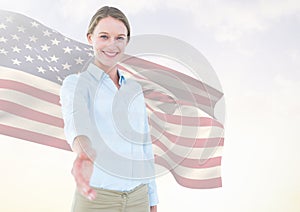 Business woman shaking her hand against american flag