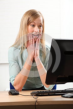 Business woman shocked and surprised by computer