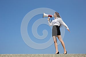 Business woman shouting megaphone