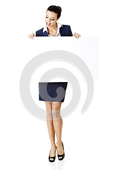 Business woman showing blank signboard