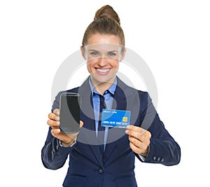 Business woman showing credit card and phone
