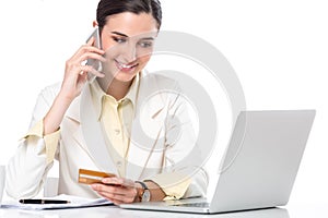 Business woman showing credit card while working