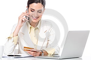 Business woman showing credit card while working