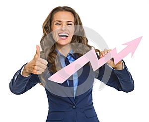 Business woman showing graph arrow going up and thumbs up