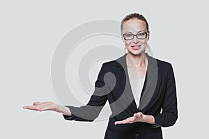 Business woman showing hand sign to side.