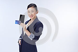 Business woman showing plastic credit card and mobile phone. concept business, shopping online, internet, blanking