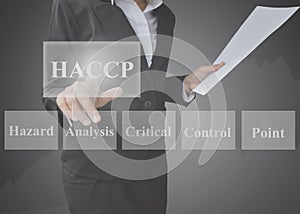 Business woman showing presentation of meaning of HACCP concept Hazard Analysis of Critical Control Points a principle on blue