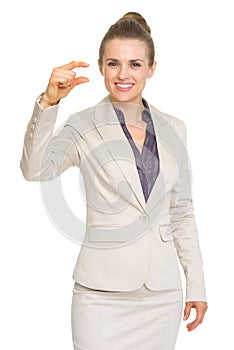 Business woman showing small risk gesture