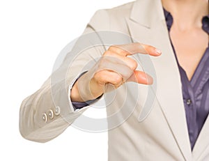 Business woman showing small risks gesture