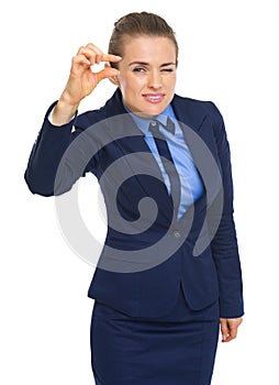 Business woman showing small risks gesture