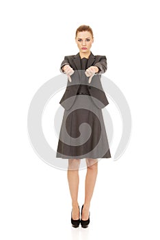 Business woman showing thumbs down.