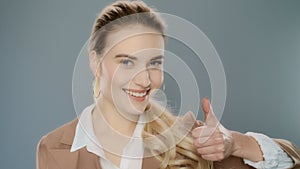Business woman showing thumbs up. Elegant person success sign